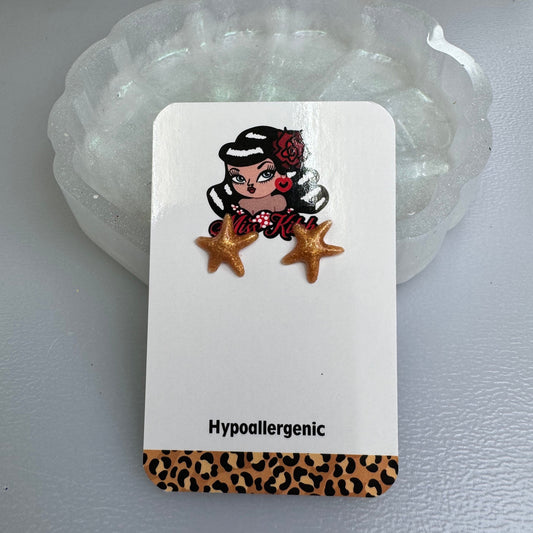 Gold starfish, hypoallergenic studs.